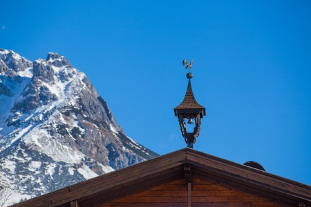 Weather-vane in the form of a cock on the roof - Austriaの写真素材