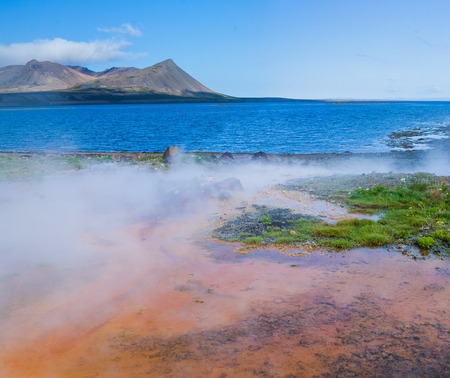 Steaming geothermal spring near Atlantic ocean in Volcanic Icelandの写真素材
