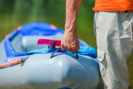 Ready kayaking  Closeup of the hand man with a kayak on the river の写真素材