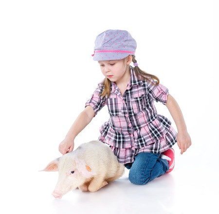 Little farmer  Cute girl with pig  Isolated on white background の写真素材
