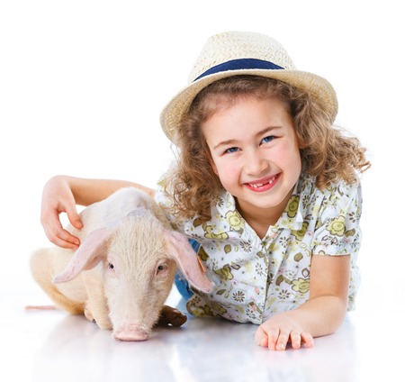 Little farmer  Cute girl with pig  Isolated on white background の写真素材