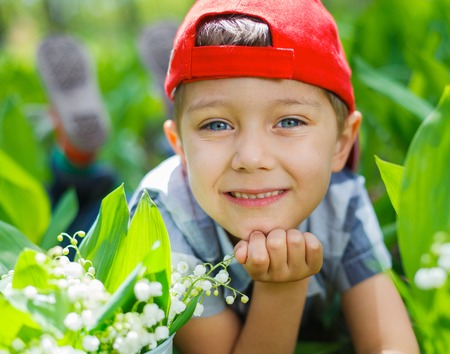Boy with lilies of the valleyの写真素材