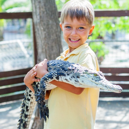 Boy with crocodile.の写真素材