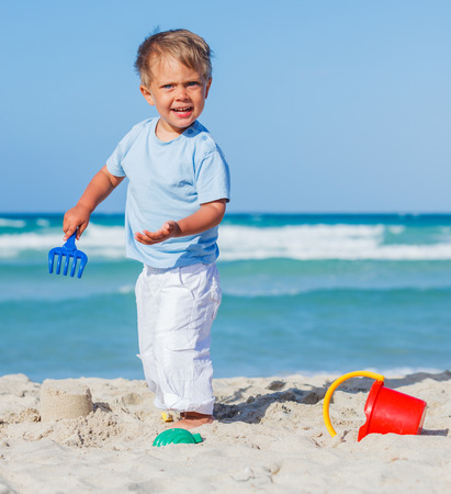 Boy playing on the beachの写真素材