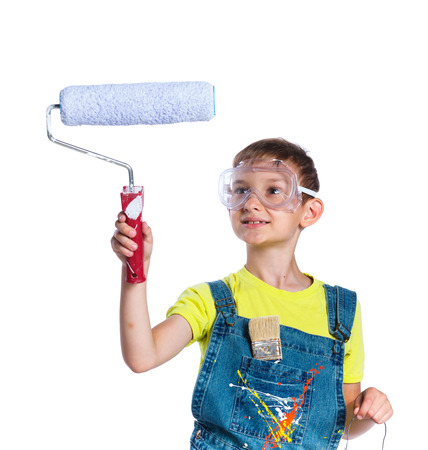 Portrait of Smiling little painter boy in uniform. Isolated over white backgroundの写真素材