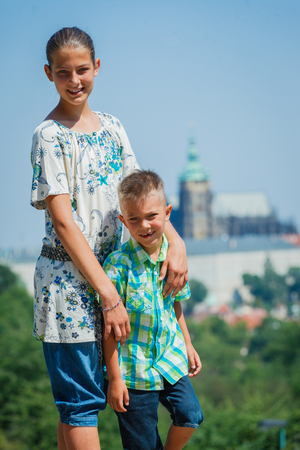 Two cute kids, sister and brother in Prague enjoying walkingの写真素材