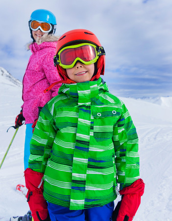 Happy skier boy with his sister enjoying winter vacation at ski resortの写真素材