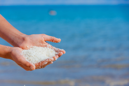 Female hands with sea salt for spa from Dead Sea. Israelの写真素材