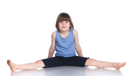 Cute little boy practice yoga. Isolated on the white backgroundの写真素材