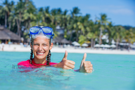Photo of happy snorkeling girl in pink swimwearの写真素材
