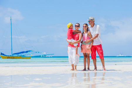 Happy family having fun on tropical beachの写真素材