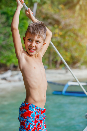Boy playing at the beach.の写真素材