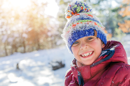 Boy playing in big snow in winter.
