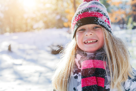 Girl playing in big snow in winter.の写真素材