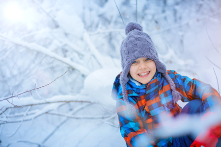 Beautiful young boy in winter parkの写真素材