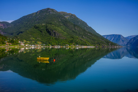 Fishing boat sailing on water with mountains in Norway.の写真素材