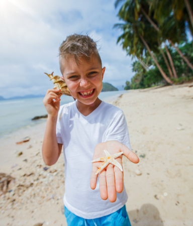 Boy playing at the beach.の写真素材