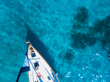 Aerial view to Yacht in deep blue sea. Drone photographyの写真素材