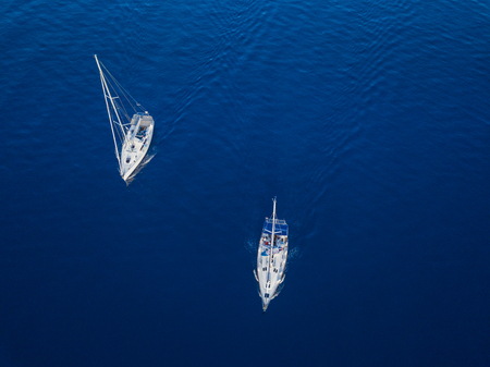 Aerial view to two Yachts in deep blue sea. Drone photographyの写真素材