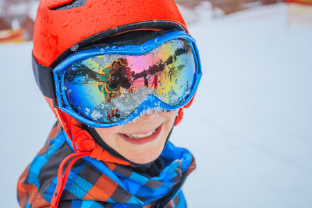 Cute skier boy in a winter ski resort.の写真素材
