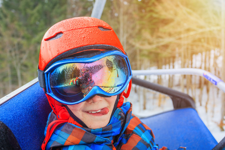 Portrait of Cute skier boy in a winter ski resort.の写真素材