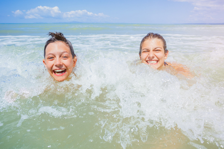 Happy kids having fun on tropical beachの写真素材