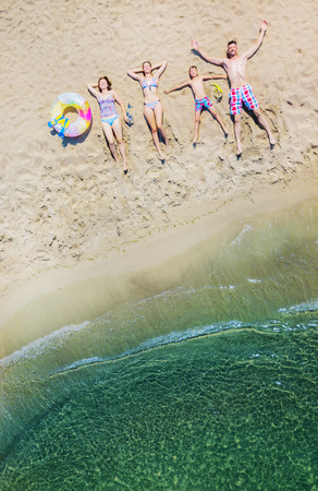 Happy family having fun in the summer leisure. Aerial drone birds eye view photo.の写真素材