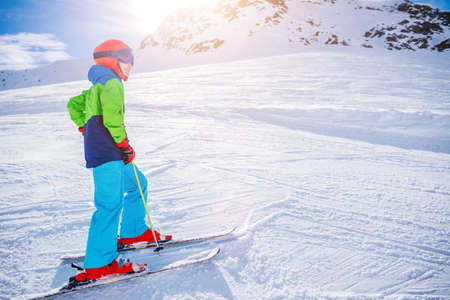 Cute skier boy in a winter ski resort.の写真素材