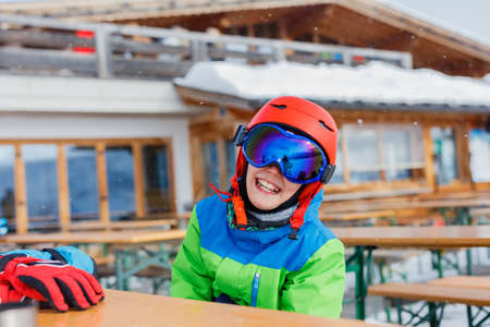 Cute skier boy in a winter ski resort.の写真素材