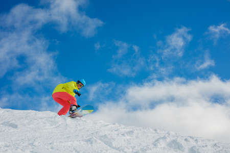 Girl snowboarder having fun in the winter ski resort.の写真素材