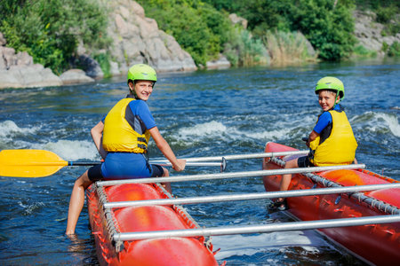 Kids and rafting. Extreme family recreation and training of athletes in raftingの写真素材