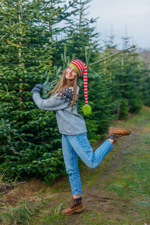 Outdoor Happy Family Choosing Christmas Tree Togetherの写真素材