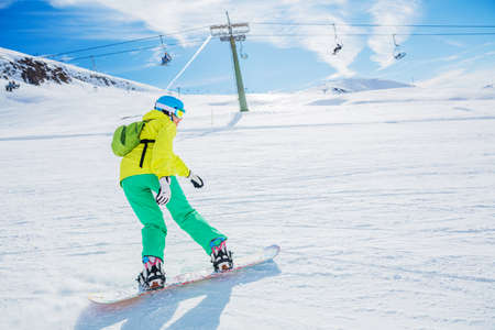 Girl snowboarder enjoys the winter ski resort.の写真素材