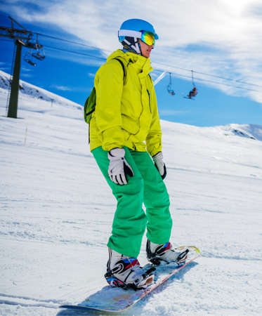 Girl snowboarder enjoys the winter ski resort.の写真素材