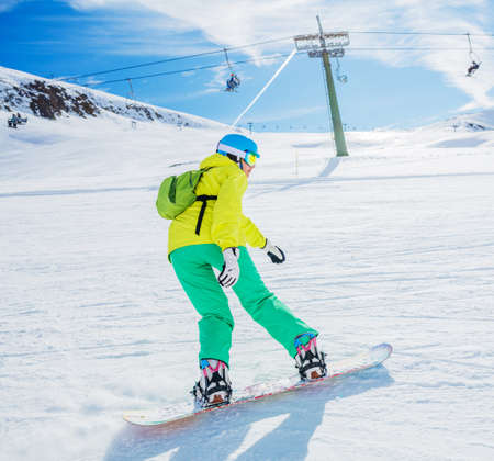 Girl snowboarder enjoys the winter ski resort.の写真素材