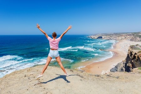 Girl having fun on the ocean. Lagos, Algarve Coast, Portugalの写真素材