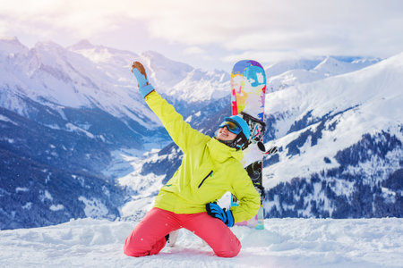 Girl snowboarder enjoys the winter ski resort.の写真素材