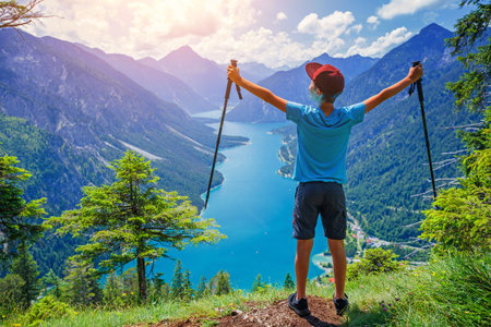 Hiker in the Alps. Boy backpacker tourist hiking at Lake.の写真素材