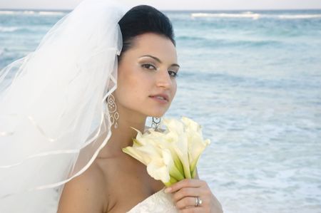 Bride on beach with her bouquetの写真素材