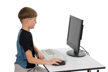 Boy on computer with cordless mouse and keyboard.