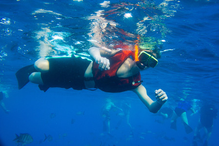 Boy snorkeling in ocean.の写真素材