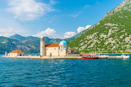 The yacht sails near the picturesque Gospa od Skrpela Island in the Boka Kotorsky Bay.のeditorial素材