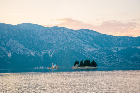 The yacht sails near the picturesque Gospa od Skrpela Island in the Boka Kotorsky Bay.の写真素材