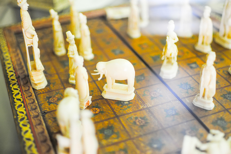 unusual vintage chess on chessboardの写真素材