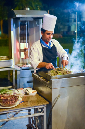 EGYPT, SHARM EL SHEIKH - DECEMBER 05/2013: the hotel chefs prepare the guest an open-air dinnerのeditorial素材