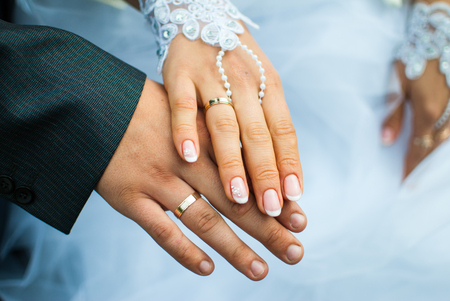 Happy bride and groom show off their ringsの写真素材