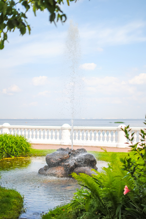 A refreshing fountain flows in a picturesque park.の写真素材