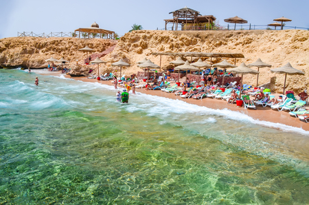 EGYPT, SHARM EL SHEIKH - 08 JUNE / 2015: Visitors at a rest on the beach near the hotel.のeditorial素材