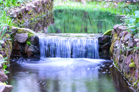 small waterfall on a small picturesque brook in the forestの写真素材