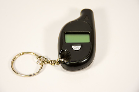 A small pressure gauge for measuring tire pressure in the form of a keychain.